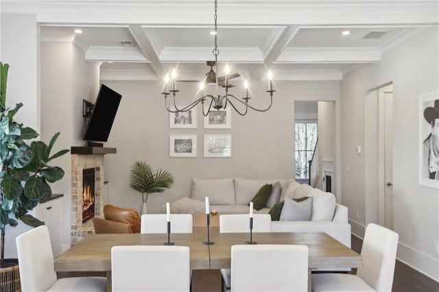 dining space with ornamental molding, coffered ceiling, and beam ceiling