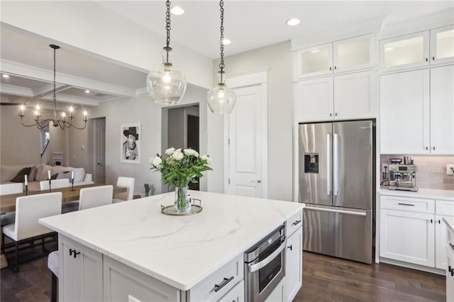 kitchen featuring a center island, stainless steel appliances, decorative light fixtures, recessed lighting, and dark wood-style floors