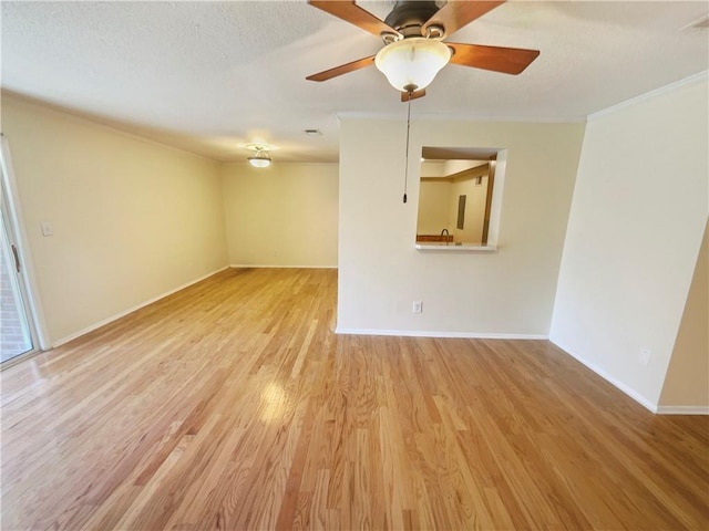 spare room featuring ceiling fan, a textured ceiling, and light wood-type flooring