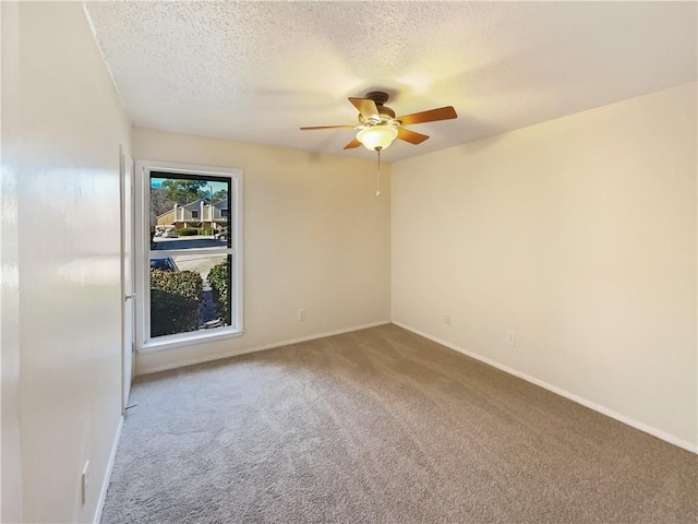 unfurnished room featuring ceiling fan, carpet floors, and a textured ceiling