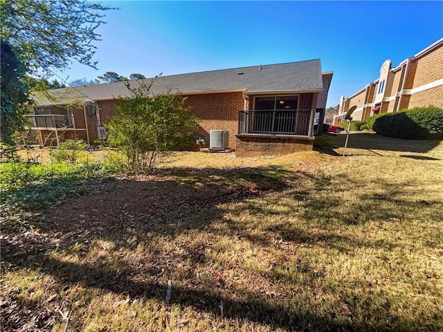 rear view of house featuring a yard and cooling unit