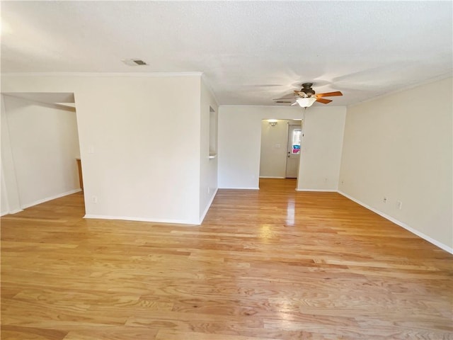 empty room with ceiling fan, ornamental molding, and light hardwood / wood-style flooring