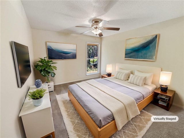 bedroom featuring ceiling fan, wood-type flooring, and a textured ceiling