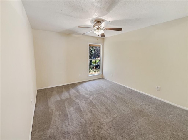 carpeted spare room with a textured ceiling and ceiling fan