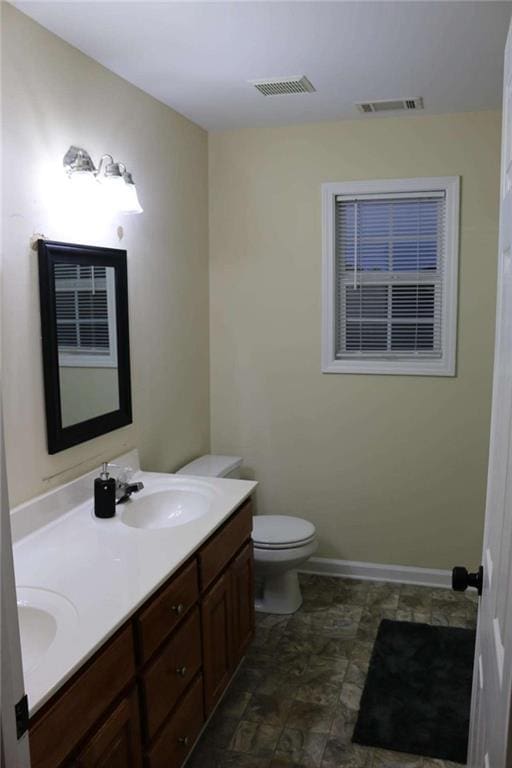 bathroom featuring vanity and toilet