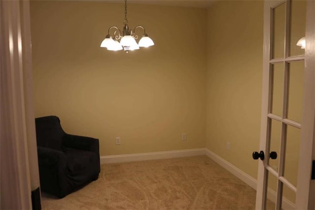 unfurnished room featuring an inviting chandelier and carpet flooring