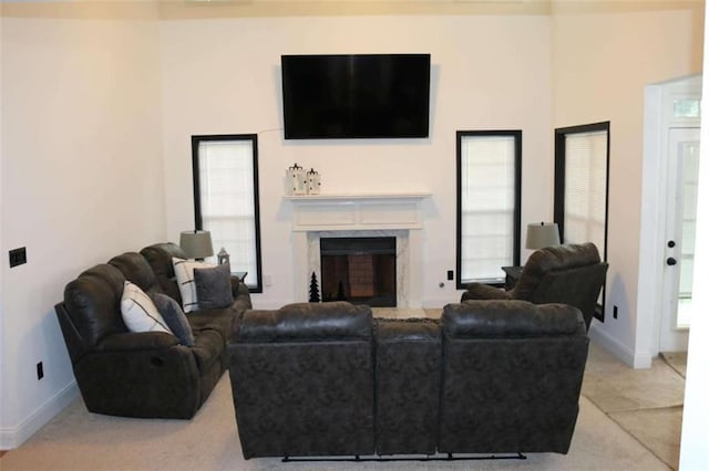 living room with a premium fireplace and plenty of natural light