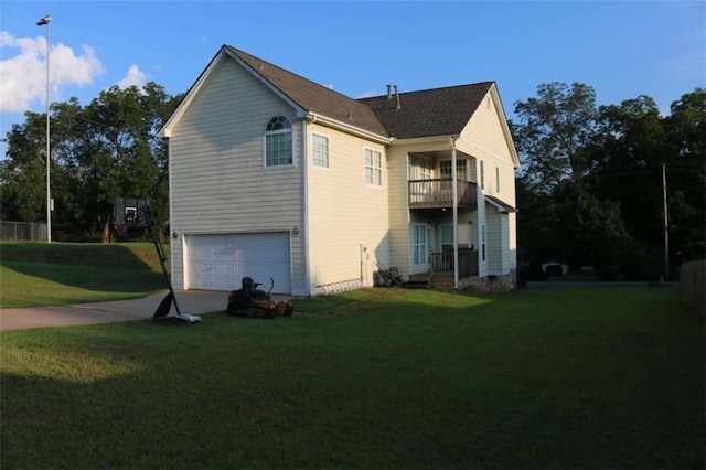 view of property exterior featuring a garage, a balcony, and a lawn