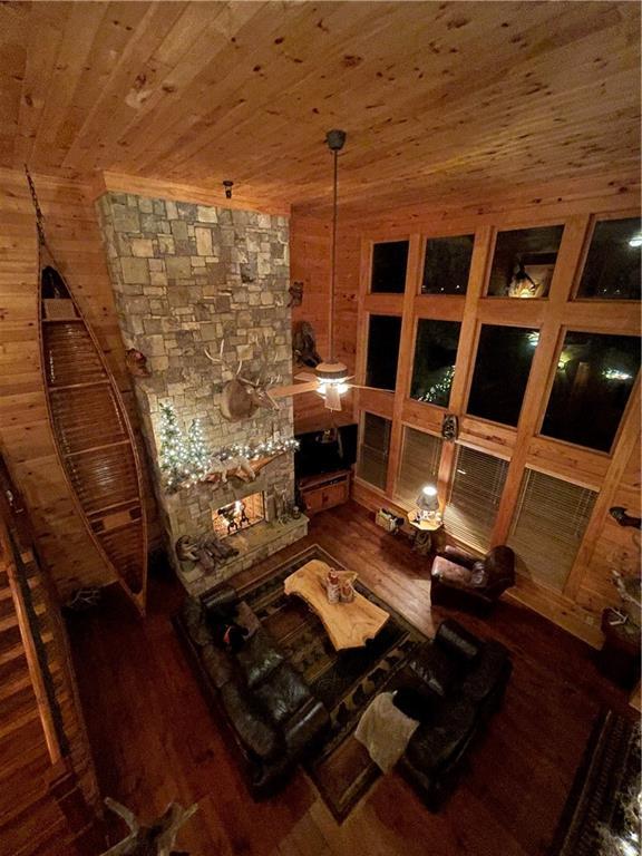 interior space featuring dark hardwood / wood-style flooring, wood walls, and wood ceiling