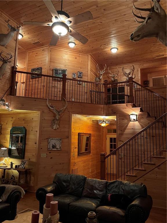 living room with ceiling fan and wooden ceiling