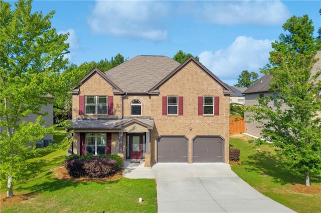 view of front of house featuring a front lawn and a garage