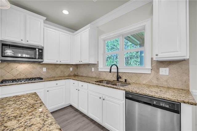 kitchen featuring sink, white cabinets, hardwood / wood-style flooring, and stainless steel appliances