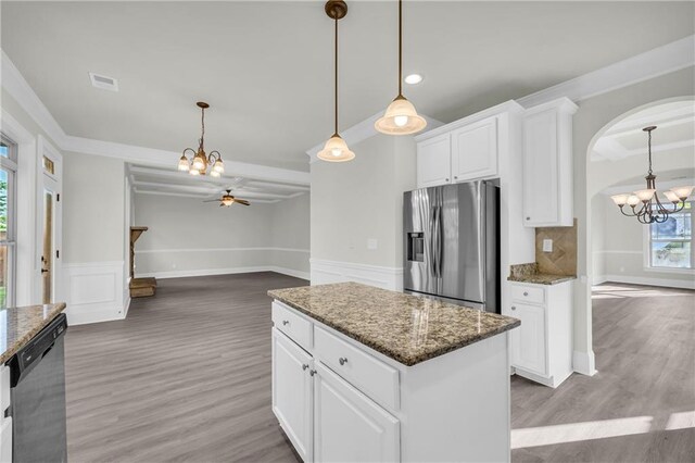 kitchen featuring stainless steel appliances, tasteful backsplash, white cabinetry, and wood-type flooring