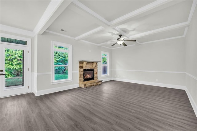 unfurnished living room featuring a stone fireplace, beam ceiling, ceiling fan, and dark hardwood / wood-style flooring