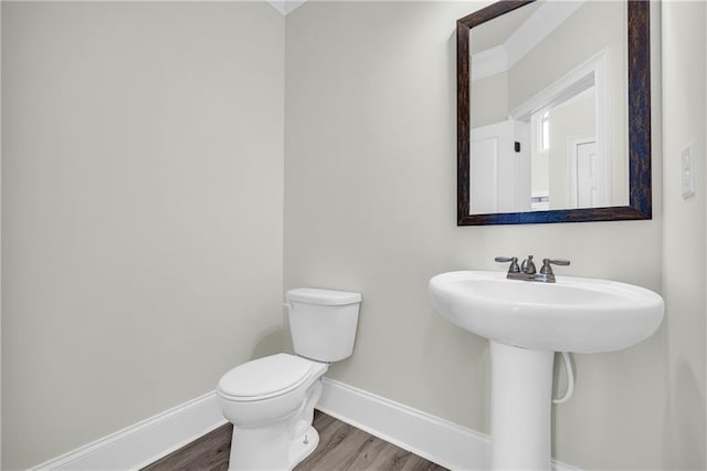 bathroom featuring toilet and wood-type flooring