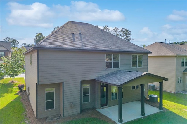 back of property with a patio and a lawn