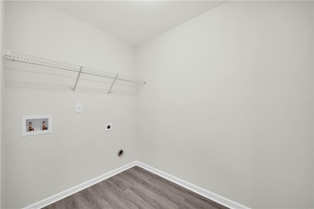 laundry area with hookup for a washing machine, hookup for an electric dryer, and wood-type flooring