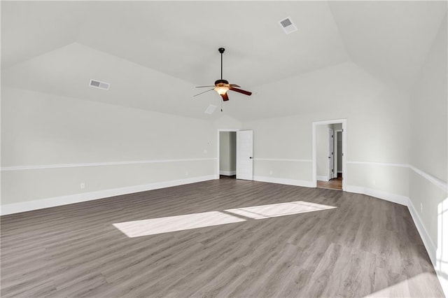 empty room with ceiling fan, hardwood / wood-style flooring, and lofted ceiling