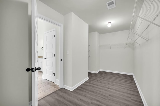 walk in closet featuring hardwood / wood-style flooring