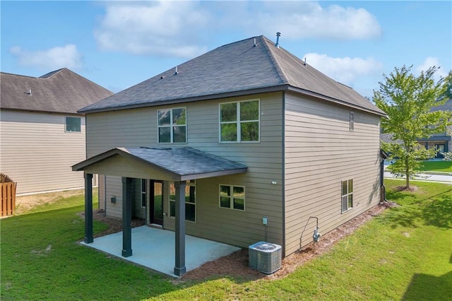 back of house with a patio, central AC unit, and a lawn