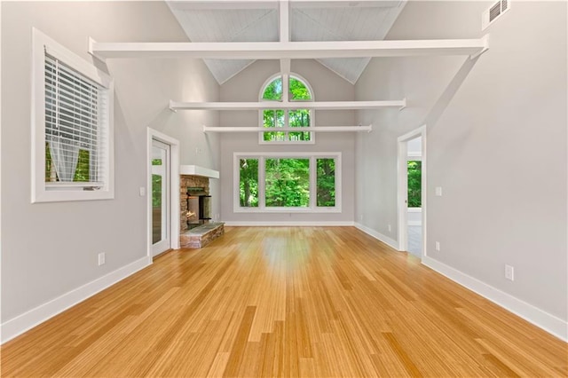 532 Coffee Cove Dr, Jasper, GA 30143 - unfurnished living room featuring wood finished floors, a fireplace, high vaulted ceiling, and baseboards