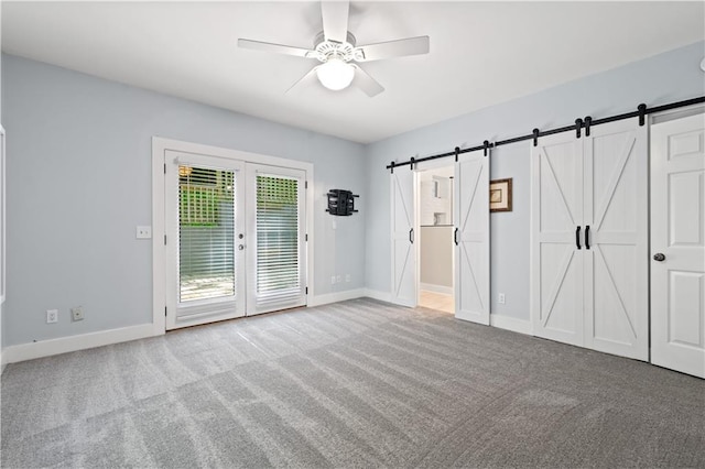 532 Coffee Cove Dr, Jasper, GA 30143 - unfurnished bedroom featuring access to exterior, a barn door, carpet flooring, and baseboards
