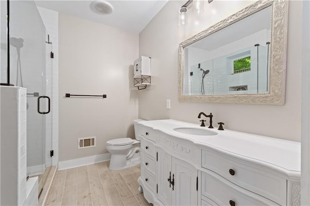 532 Coffee Cove Dr, Jasper, GA 30143 - bathroom with vanity, a stall shower, toilet, baseboards, and wood finished floors