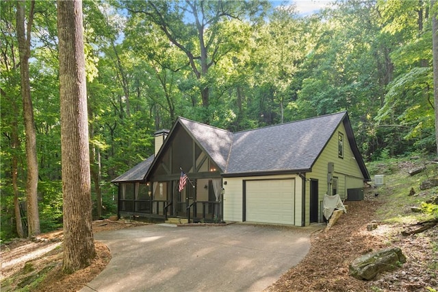 532 Coffee Cove Dr, Jasper, GA 30143 - view of front of house featuring concrete driveway, a chimney, central air condition unit, roof with shingles, and an attached garage