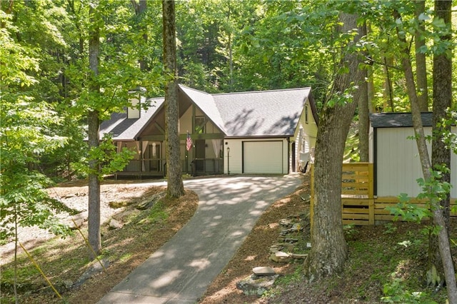 532 Coffee Cove Dr, Jasper, GA 30143 - view of front of house with an attached garage, concrete driveway, a porch, a chimney, and a shed