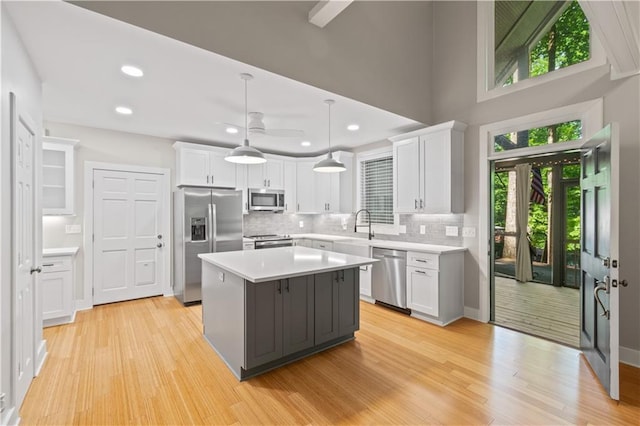 532 Coffee Cove Dr, Jasper, GA 30143 - kitchen with stainless steel appliances, white cabinetry, ceiling fan, light countertops, and decorative backsplash