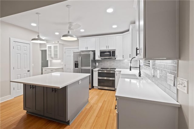 532 Coffee Cove Dr, Jasper, GA 30143 - kitchen featuring appliances with stainless steel finishes, ceiling fan, a sink, tasteful backsplash, and recessed lighting