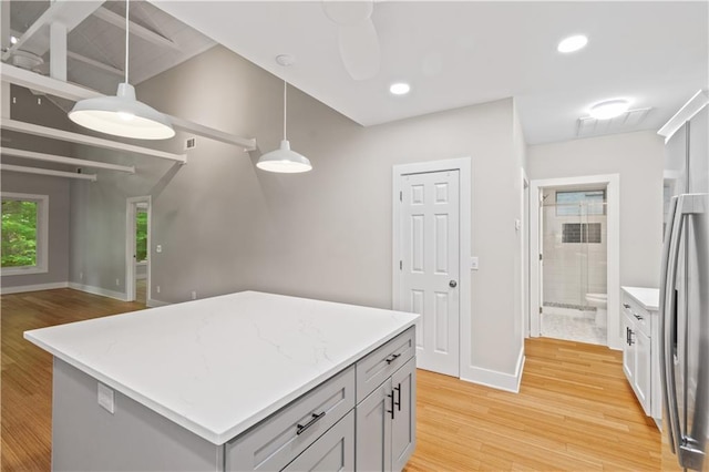 532 Coffee Cove Dr, Jasper, GA 30143 - kitchen with light wood-style floors, baseboards, stainless steel fridge, hanging light fixtures, and a kitchen island