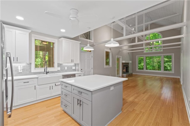 532 Coffee Cove Dr, Jasper, GA 30143 - kitchen with a sink, freestanding refrigerator, ceiling fan, decorative backsplash, and plenty of natural light