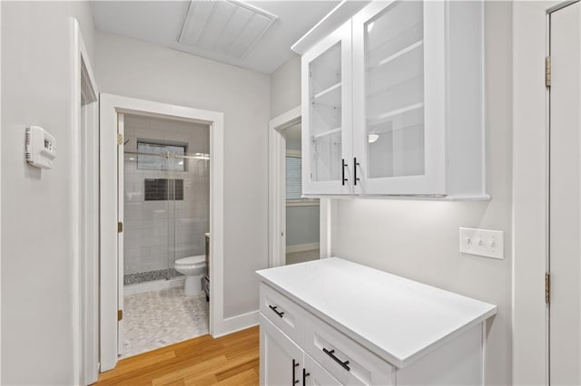 532 Coffee Cove Dr, Jasper, GA 30143 - full bathroom featuring a shower stall, toilet, wood finished floors, and baseboards