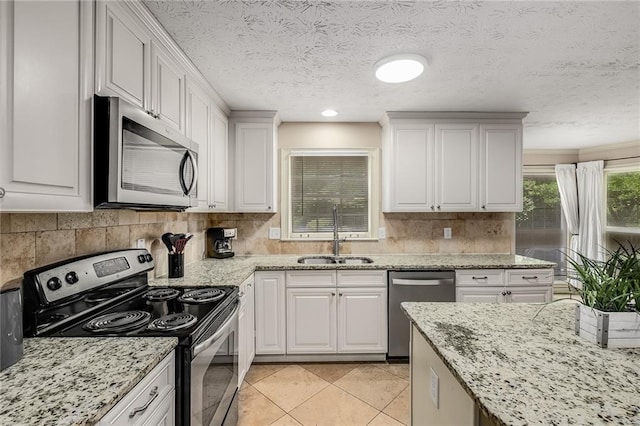 kitchen with white cabinetry, stainless steel appliances, and sink