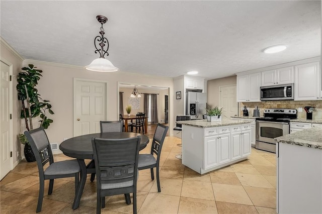 kitchen with white cabinetry, decorative light fixtures, light stone countertops, appliances with stainless steel finishes, and light tile patterned flooring