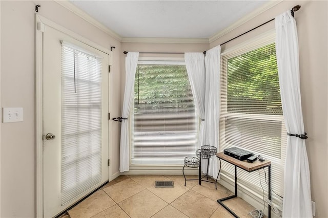 entryway featuring crown molding and light tile patterned floors