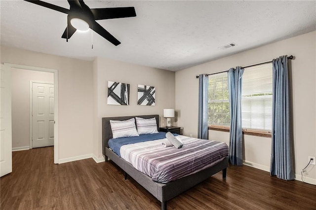 bedroom with ceiling fan and dark hardwood / wood-style flooring