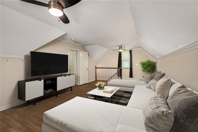 living room featuring dark wood-type flooring, ceiling fan, ornamental molding, and vaulted ceiling