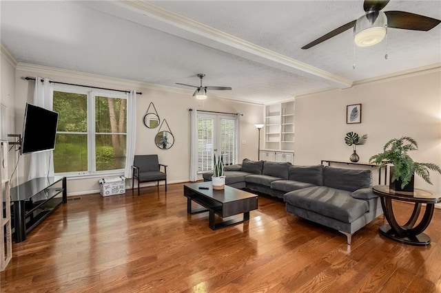 living room with plenty of natural light, hardwood / wood-style floors, and ceiling fan