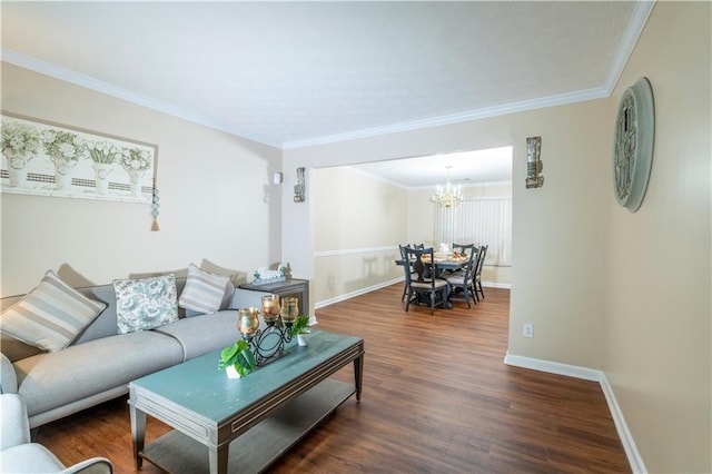 living room with a notable chandelier, crown molding, baseboards, and wood finished floors