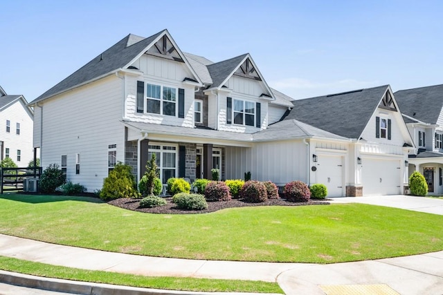 view of front of property with board and batten siding, a front lawn, and concrete driveway