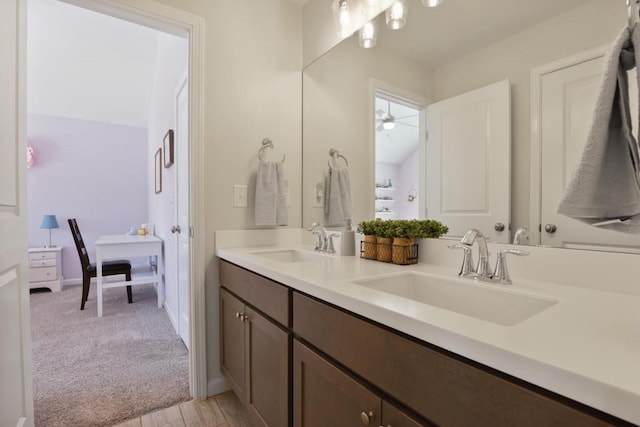 bathroom with a sink, double vanity, and ensuite bath