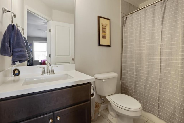 bathroom with toilet, vanity, tile patterned flooring, and a shower with curtain