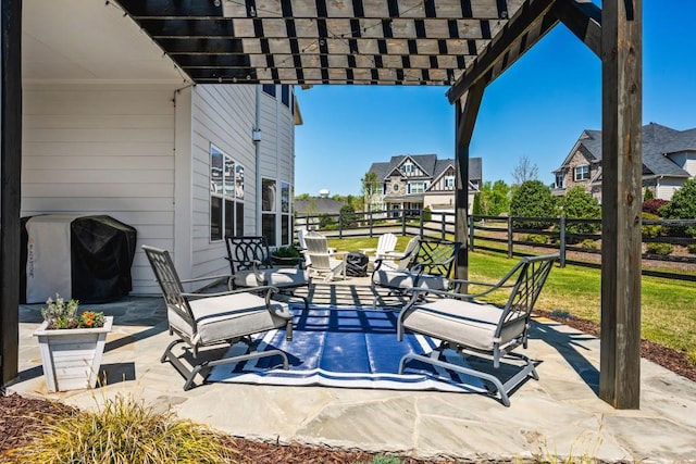 view of patio with area for grilling, a pergola, and fence