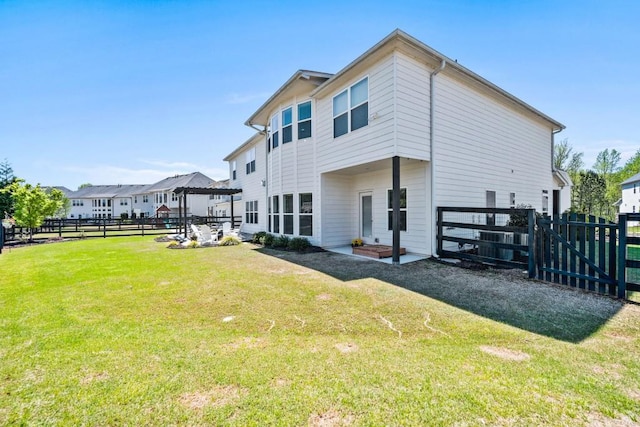 back of house with a patio, a yard, and fence