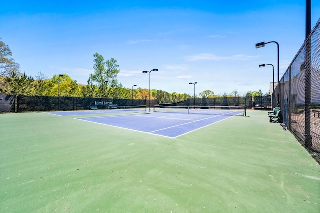 view of tennis court with fence