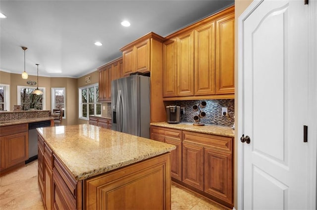 kitchen featuring backsplash, brown cabinets, appliances with stainless steel finishes, and a center island