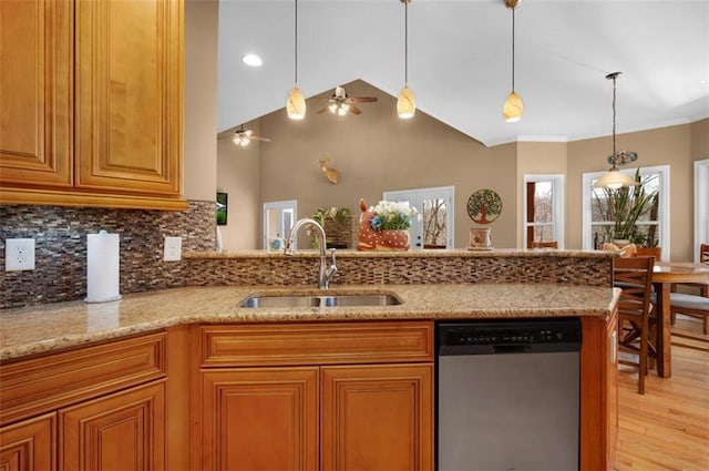 kitchen with light stone countertops, a sink, pendant lighting, stainless steel dishwasher, and brown cabinets