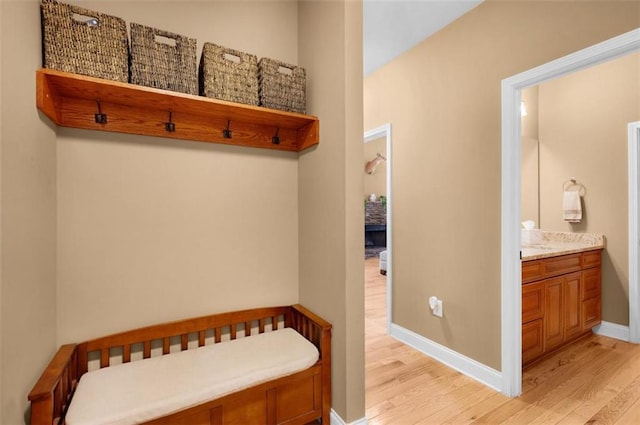 mudroom featuring baseboards and light wood-style floors